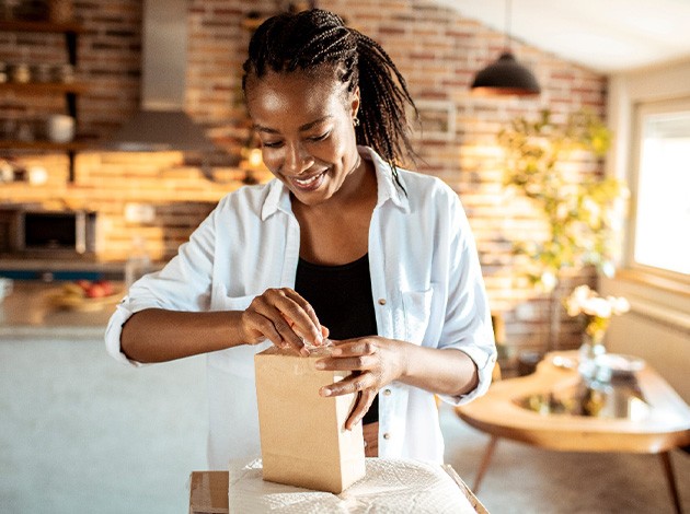 Woman opening mailed package