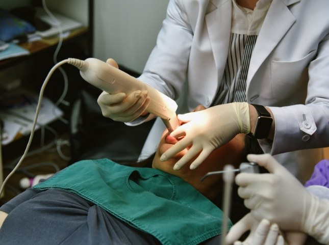 Dentist taking digital dental impressions of a patient