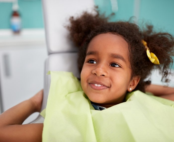 Close up of smiling child with braces on their lower teeth