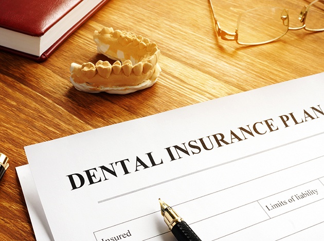 Dental insurance plan document on desk