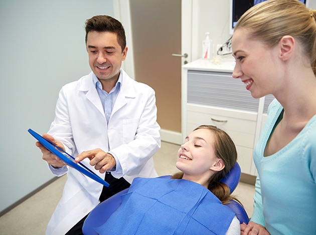 Mom and teen daughter interacting with dentist