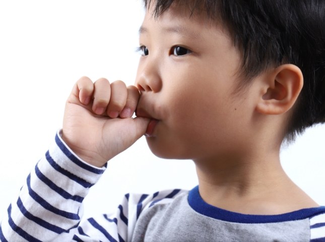 Young boy sucking his thumb