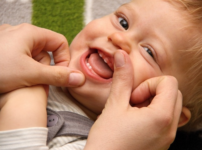 Person looking at a teething baby