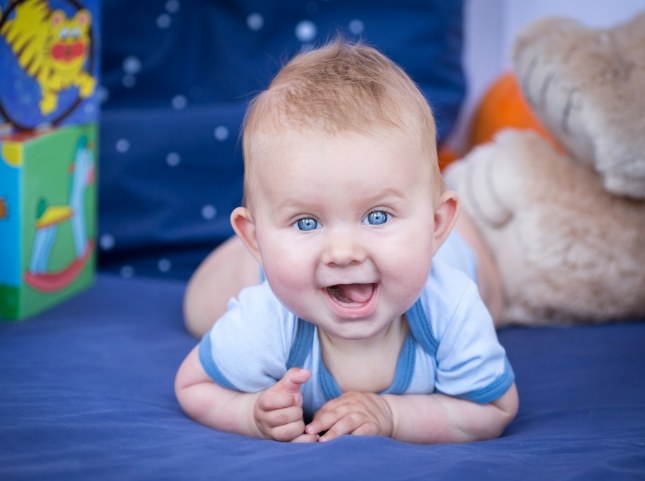 Smiling baby crawling on the floor