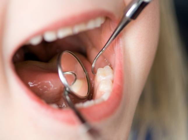 Close up of dentist giving a child a dental exam