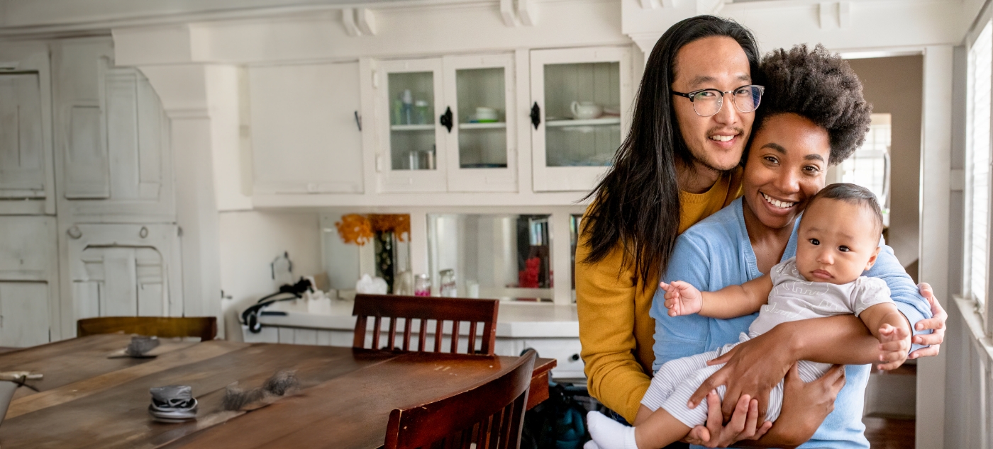 Mother and father holding their baby after visiting dentist for infants in Newark