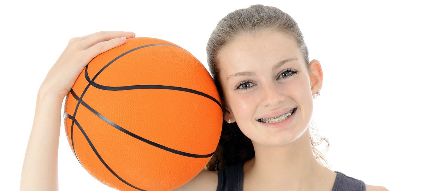 Girl with braces holding a basketball