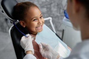 Young girl smiling after her lip tie treatment