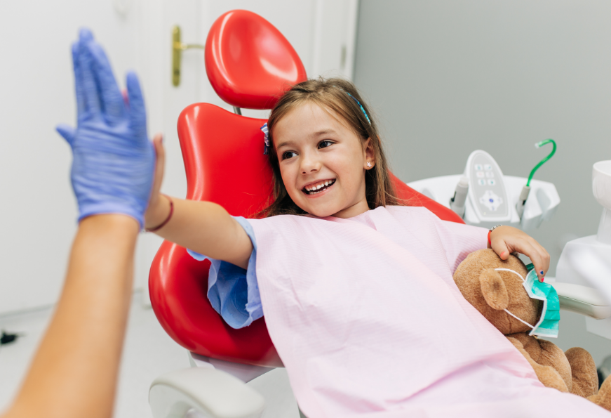 Child high-fiving dentist