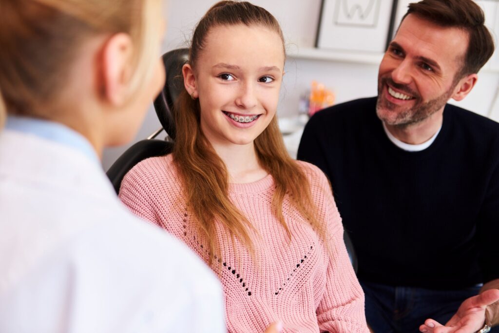 Patient and her father discussing treatments with orthodontist